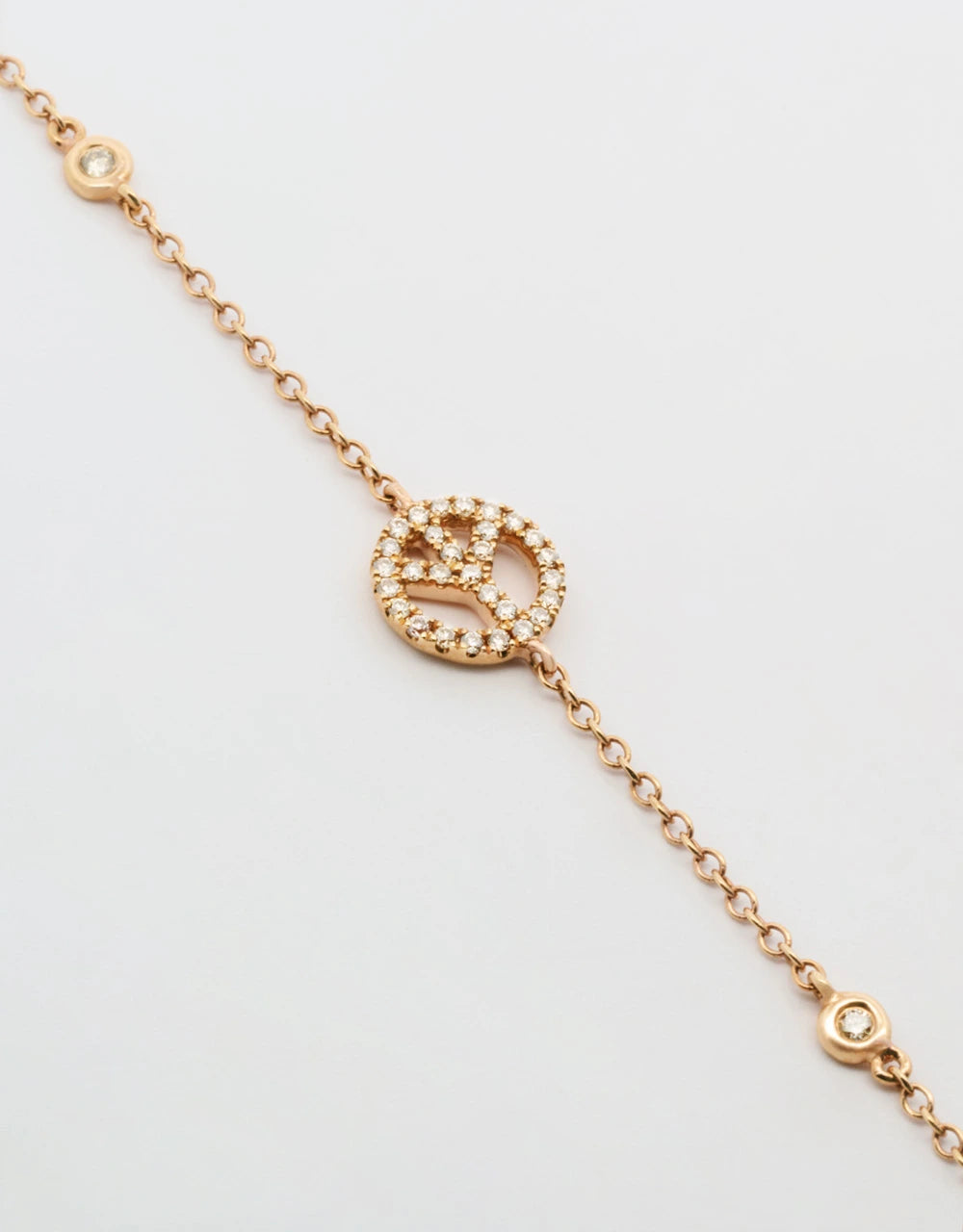 Pulsera símbolo paz de diamantes en oro rojo de 18k